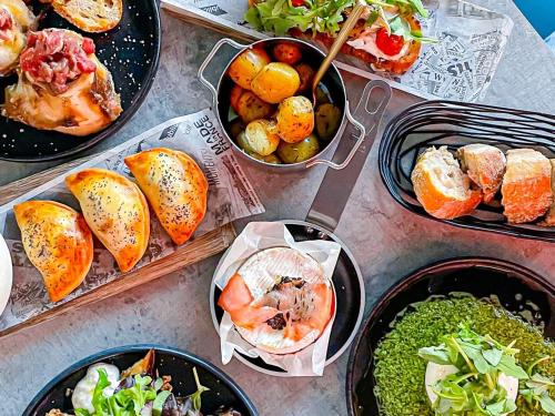 a table topped with different types of food in pans at Novotel Bordeaux Centre Ville in Bordeaux