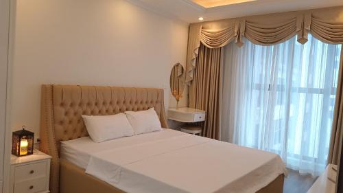 - une chambre avec un lit et une grande fenêtre dans l'établissement Goldmark city 3PN sang trọng, à Hanoï