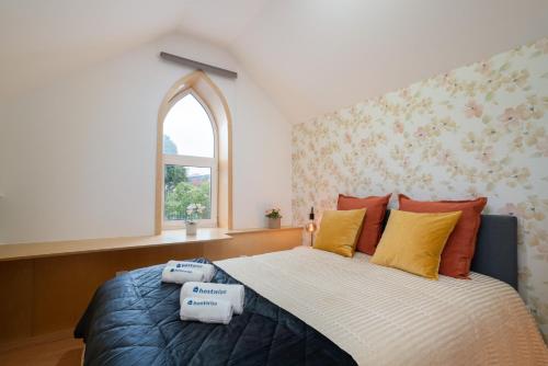 a bedroom with a large bed with a window at Host Wise - Central Duplex House - Terrace in Vila Nova de Gaia