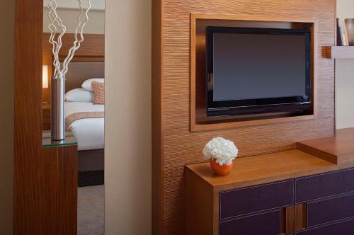 a hotel room with a television and a bedroom at Grand Hyatt San Francisco Union Square in San Francisco