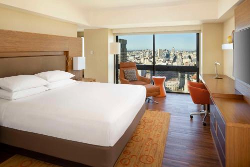 a bedroom with a large white bed and a desk at Grand Hyatt San Francisco Union Square in San Francisco