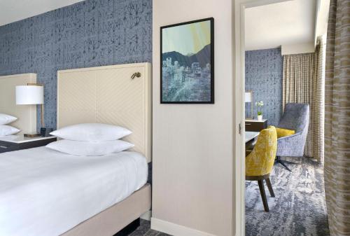 a hotel room with a bed and a desk at Hyatt Regency Vancouver in Vancouver