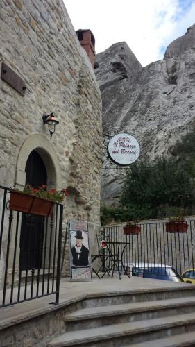 een gebouw met een bord aan de zijkant bij Il Palazzo del Barone - Stanza dei Calì in Pietrapertosa