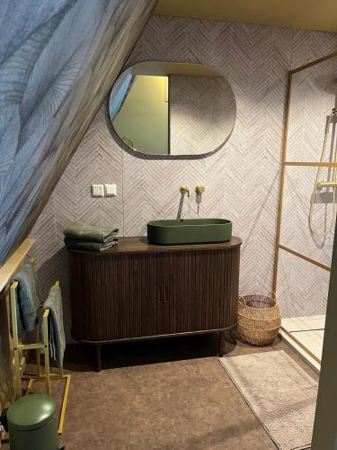 a bathroom with a sink and a mirror in a tent at Bed bij Bistro in Medemblik