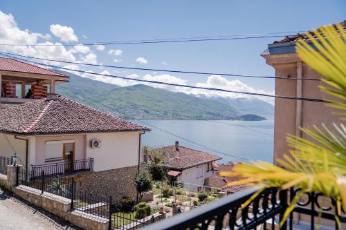 a view from a balcony of houses and the water at Villa & Spa Chunarot in Ohrid