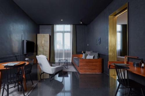 a living room with a couch and a table and chairs at Umbral, Curio Collection By Hilton in Mexico City