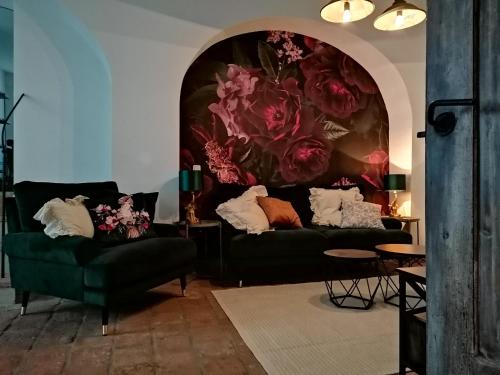 - un salon avec deux canapés et un tableau de fleurs dans l'établissement Peter, à Görlitz