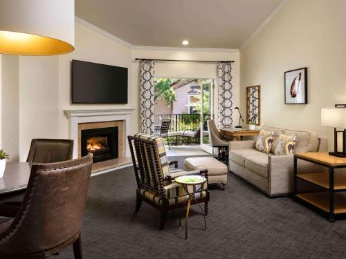a living room with a couch and a fireplace at Fairmont Sonoma Mission Inn & Spa in Sonoma