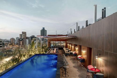 a pool on the rooftop of a building with a view at Doubletree By Hilton Lima San Isidro in Lima