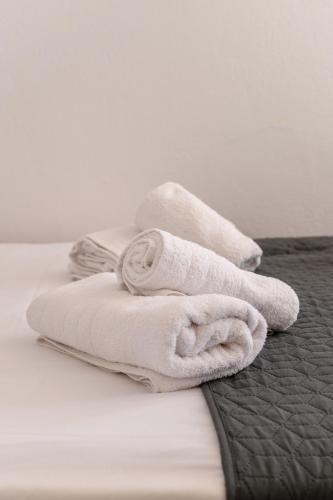 a pile of towels sitting on top of a bed at Bonzoe #5 in Parikia
