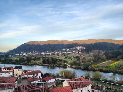 a view of a town next to a river at Casinha da Ladeira 3360 in Penacova