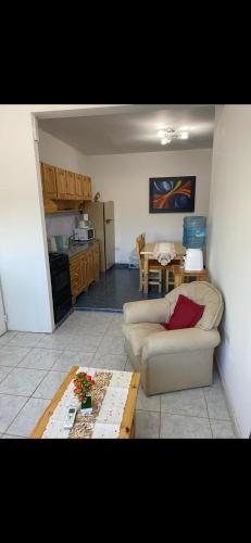 a living room with a couch and a table at Acordes de Gaitas - Departamento 1 in Malargüe