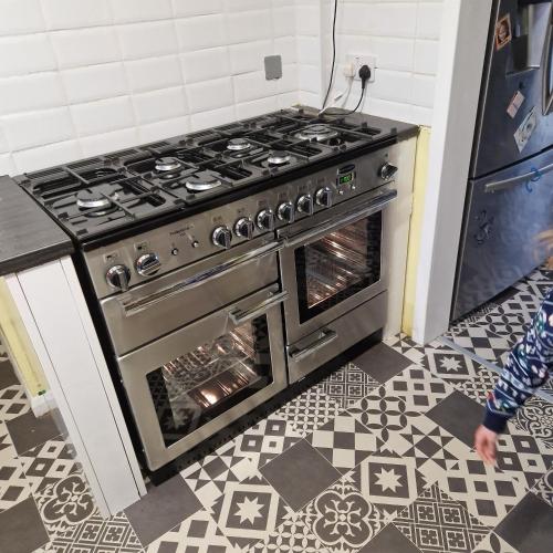 um fogão numa cozinha com piso em azulejo em Guest house with appliances em Brixworth