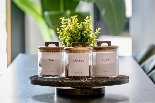 three candles on a table with a vase of flowers at City Retreat with Parking at Apartment 26 in York