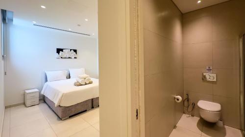 a bedroom with a bed and a toilet in a room at City Napa Seaview Villas - Villa 6 in Ayia Napa