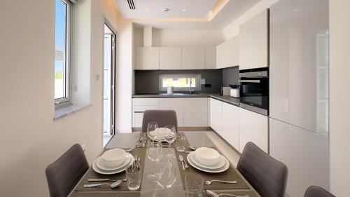 a dining room with a table and chairs in a kitchen at City Napa Seaview Villas - Villa 6 in Ayia Napa