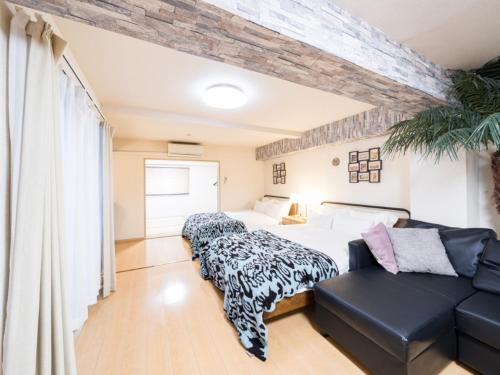 a bedroom with a bed and a couch at Shinjuku, 1min walk from Kagurazaka Sta ,80square meters,net, PocketWiFi, Switch in Tokyo