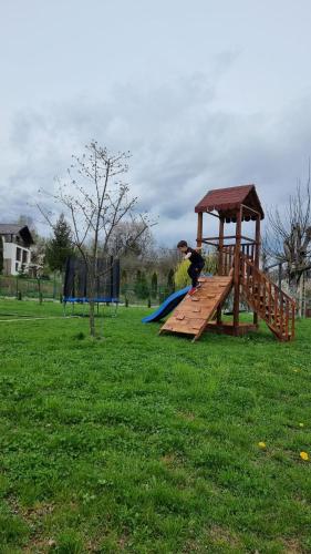 a person riding a skateboard on a wooden playground at Vila MOON in Bezdead