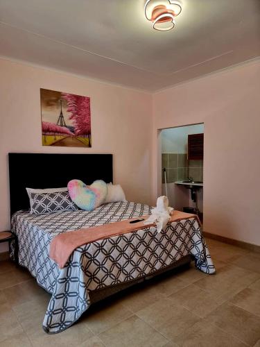 a bedroom with a large bed with aokedokedokedoked at Danrit Guesthouse - Uncapped wifi in Roodepoort
