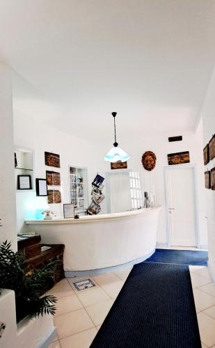 a room with a large white tub in a room at Hotel Poseidon in Lipari