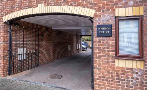 an entrance to a brick building with an open gate at 2 Bed Apt,Parking,Long Stay Offers,Reading Centre in Reading