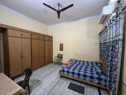 a bedroom with a bed and a ceiling fan at Vishwa Deva Homestay in Varanasi