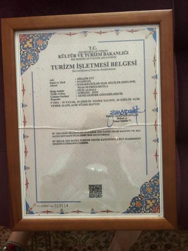 a picture of a certificate in a wooden frame at Misafir Evi in Kayakoy