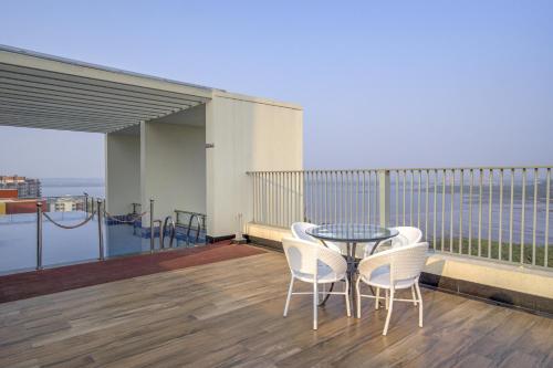 a balcony with a table and chairs on a balcony at 2BHK 10 min drive to GOI airport & beach at Dabolim in Vasco Da Gama