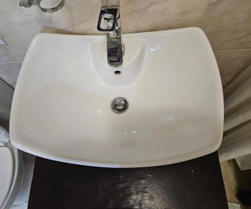 a white sink with a faucet in a bathroom at The Royal Princess B&B on Malibongwe Drive in Johannesburg