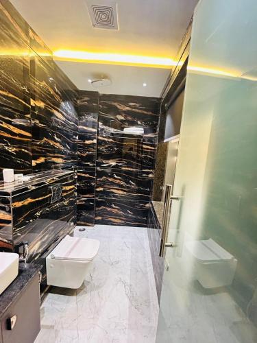 a bathroom with two toilets and a glass shower at Taj Dream A Luxury Hotel - Agra in Agra