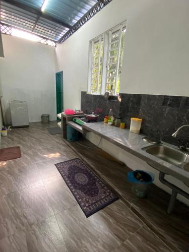 a kitchen with a sink and a counter top at Swedish Style Homestay in Teluk Intan