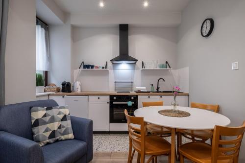 a kitchen with a table and chairs in a room at 29 Gdynia Centrum - Apartament Mieszkanie dla 4 os in Gdynia