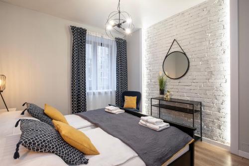 a bedroom with a large bed and a brick wall at 29 Gdynia Centrum - Apartament Mieszkanie dla 4 os in Gdynia