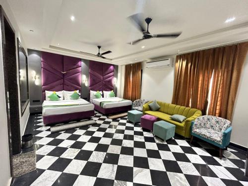 a living room with two beds and a checkered floor at Taj Ronak Luxury Hotels in Agra