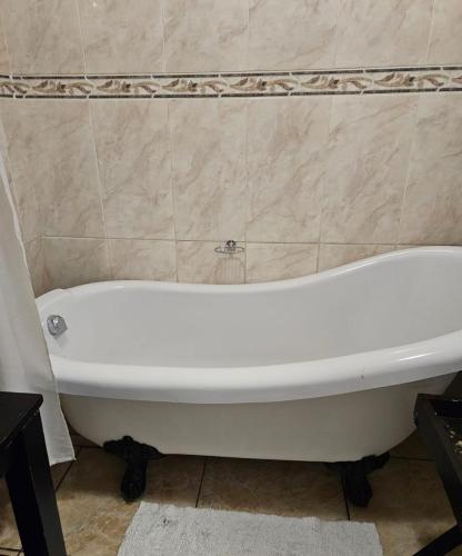 a white bath tub sitting in a bathroom at The Royal Princess B&B on Malibongwe Drive in Johannesburg
