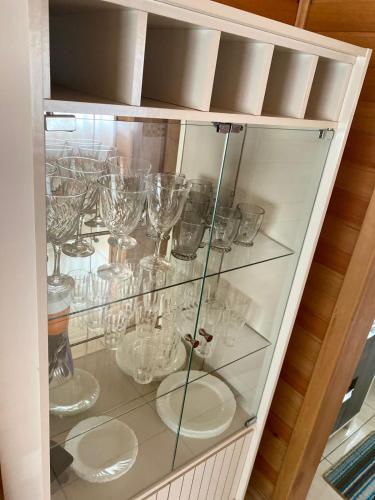 a glass cabinet filled with glasses on display at Cabanas das Araucárias in Urubici