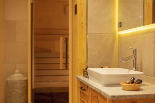 a bathroom with a white sink and a mirror at PRIVILLAGE Stare - B&B in Bohinj