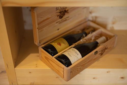 a wooden box with bottles of wine in it at PRIVILLAGE Stare - B&B in Bohinj