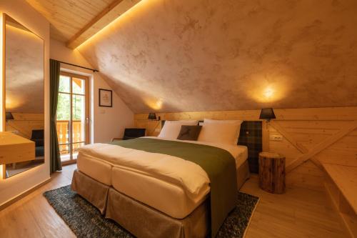 a bedroom with a large bed in a room at PRIVILLAGE Stare - B&B in Bohinj