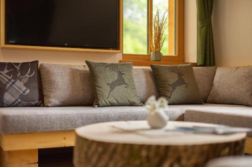 a living room with a couch and a table at PRIVILLAGE Stare - B&B in Bohinj