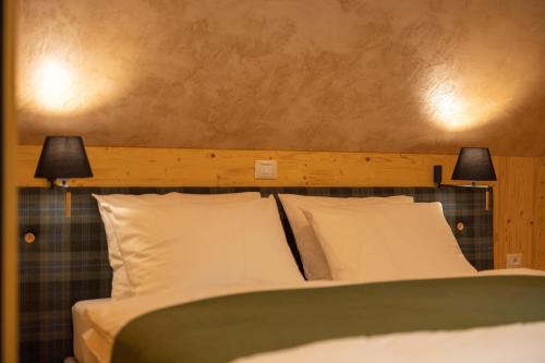 a bedroom with a bed with two lamps on it at PRIVILLAGE Stare - B&B in Bohinj