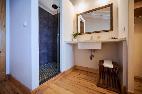 a bathroom with a shower and a sink and a mirror at Casa La Baranda in Chulilla