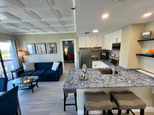 a kitchen and living room with a counter and a couch at Rooftop Terrace 2 Bedroom Tangerine Suite - Perfect View, Central Location in Orlando