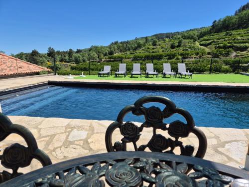 a view of a swimming pool with lounge chairs at Quinta do Limite - Casa do Camponês in Covilhã