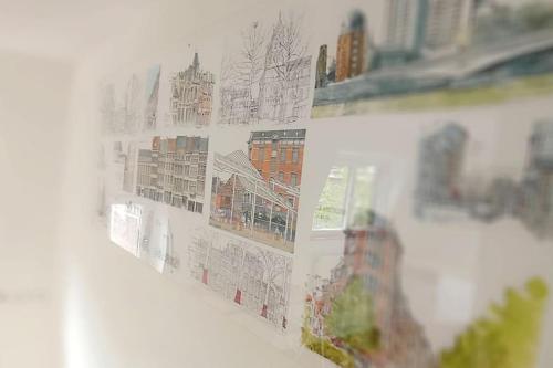 a wall with drawings of buildings on it at Dans l'impasse in Liège