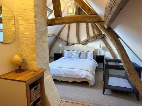 a bedroom with a bed in an attic at Charming converted Granary in Capelle-lès Hesdin