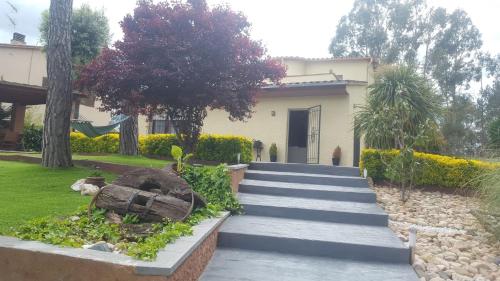 a house with a staircase in front of it at Villadora in Santa Coloma de Farners