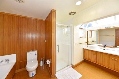 a bathroom with a toilet and a sink and a shower at Father House in Kaiapoi