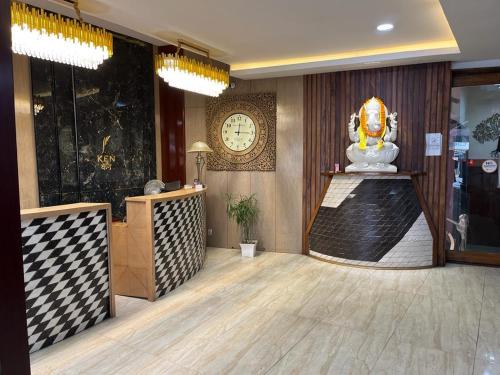 a lobby with a clock on the wall and a desk at Hotel Ken in Rānchī