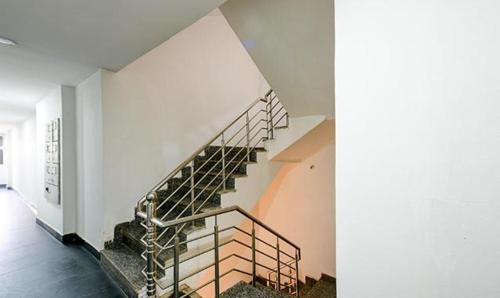 a staircase in a house with a white wall at FabExpress The Maharaja Grand in New Delhi